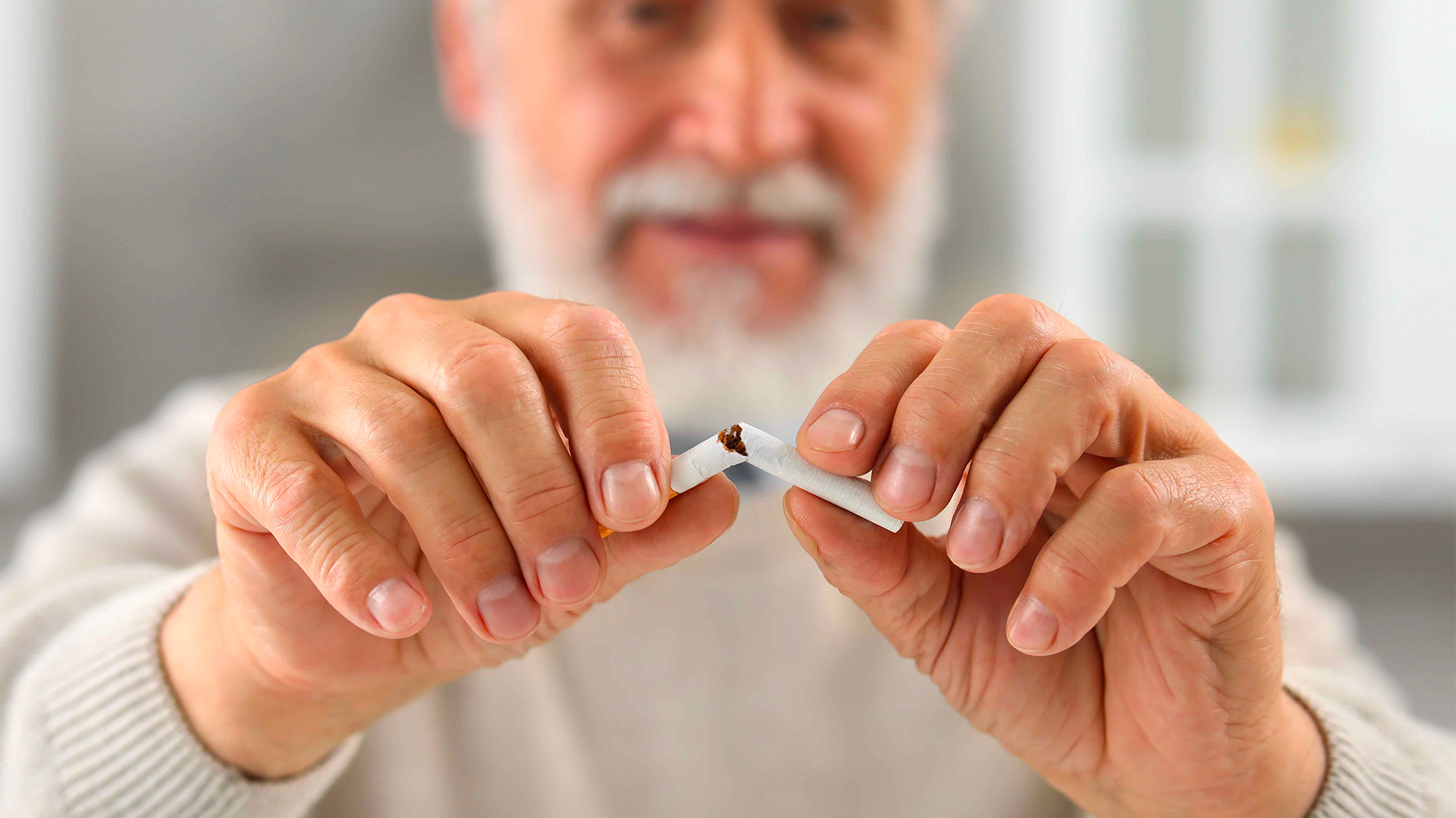 uomo spezza sigaretta per evitare l’insorgenza dei denti gialli